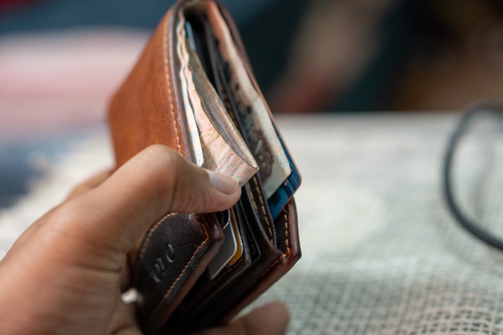 a person holding a wallet in their hand