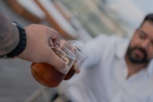 A man holding a beer in a plastic cup