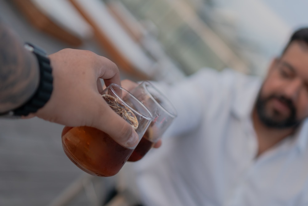 A man holding a beer in a plastic cup
