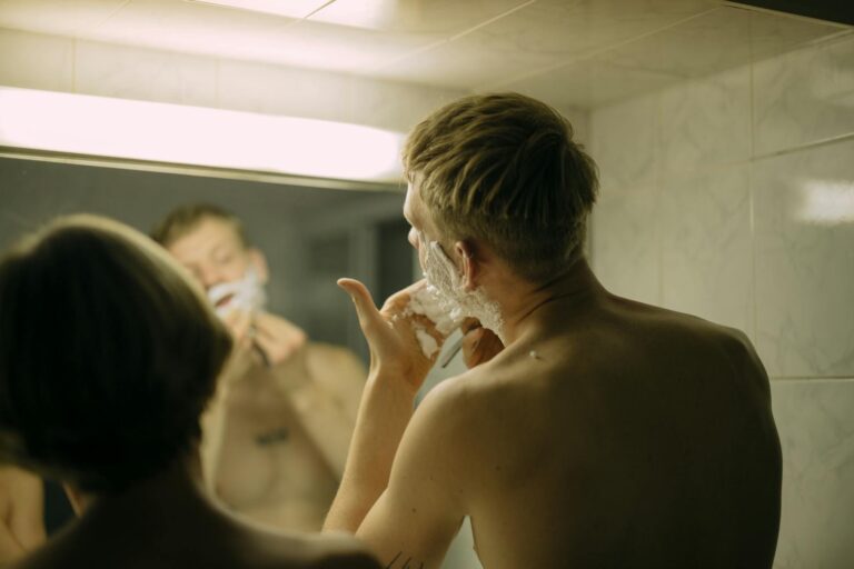 older brother shaving by mirror