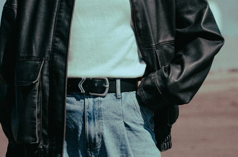 A man wearing a black leather jacket and jeans