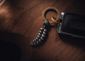 a camera and a keychain on a wooden table