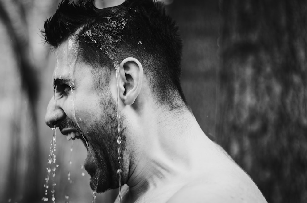 Home 14 a man drinking water from a faucet