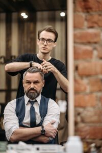 a hairdresser styling hair of a man